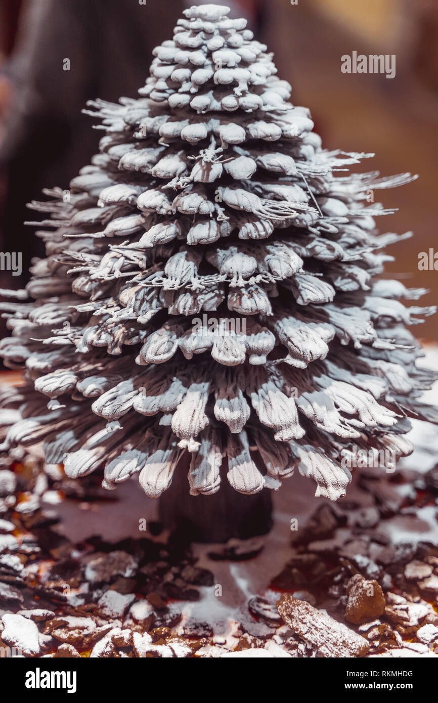 Lisbon, Portugal - 12/26/18: Miniature chocolate christmas tree model made of pure chocolate sprinkled with sugar. Chocolate Pine tree with needles. Stock Photo