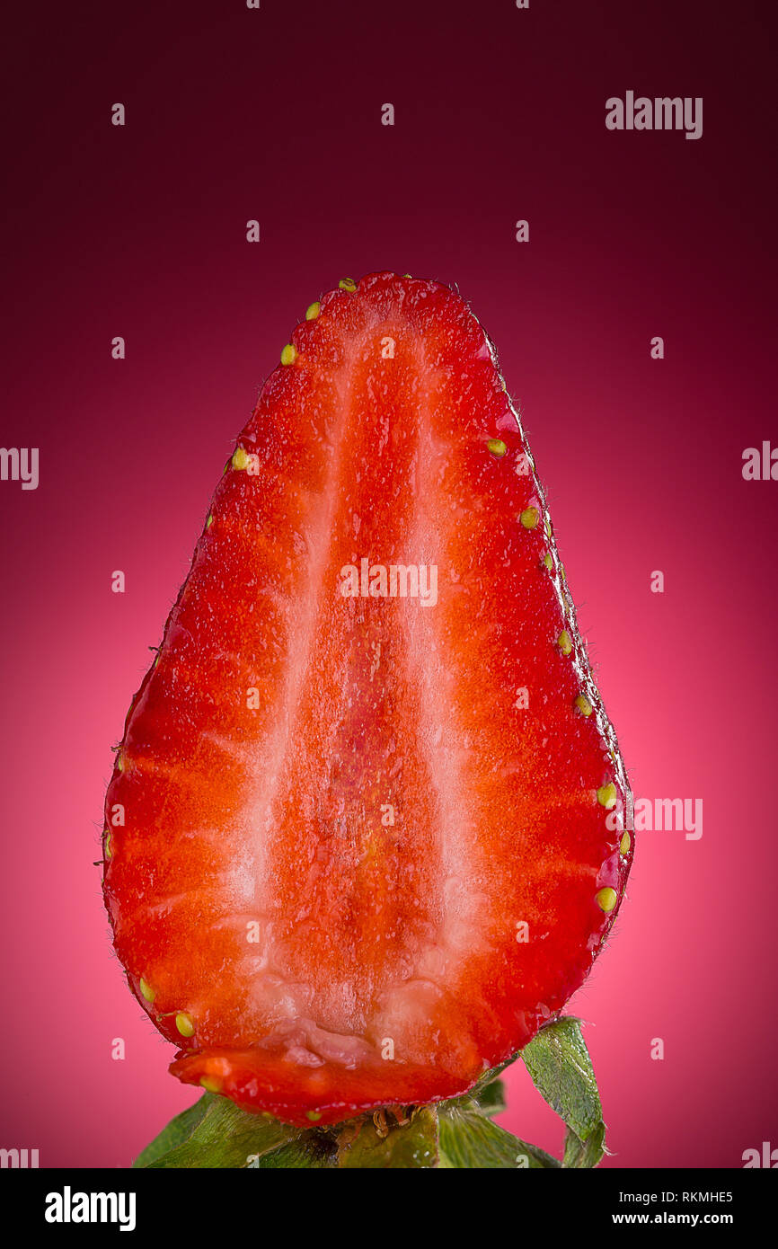 strawberry on red background close up Stock Photo - Alamy