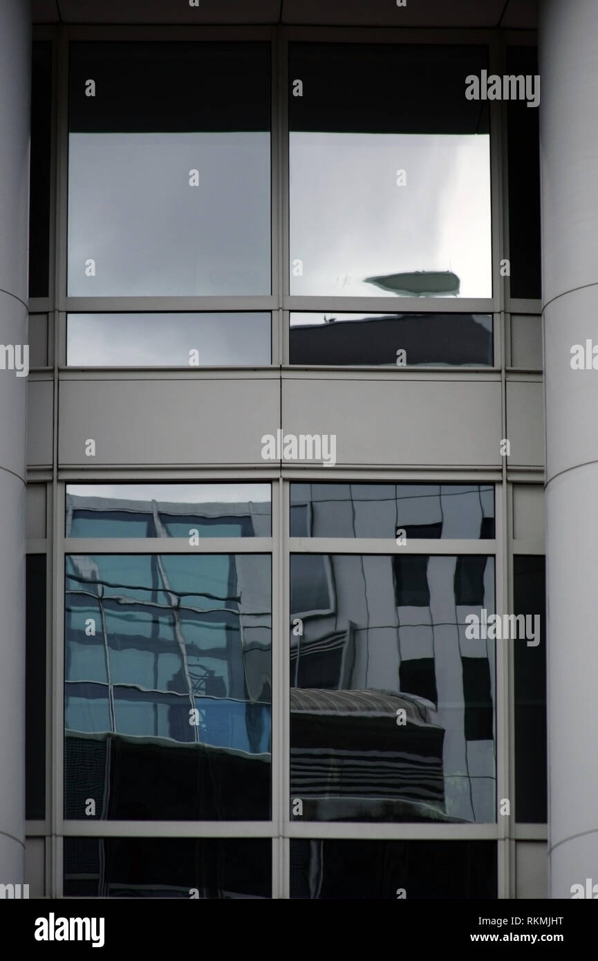 Reflections and details of surrounding trade fair buildings in the facade of a hall of Messe Berlin. Stock Photo