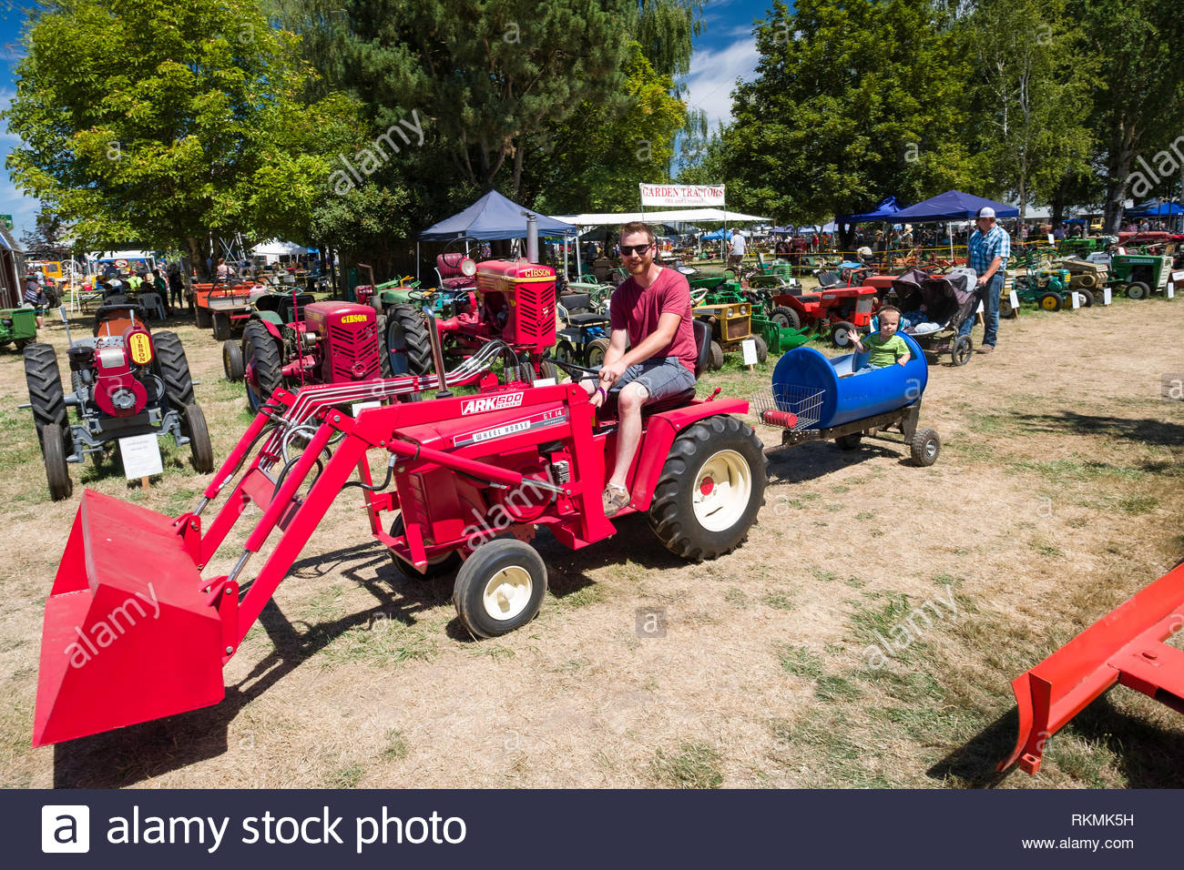 Young Man Driving A Wheel Horse Gt 14 Garden Tractor With An Ark