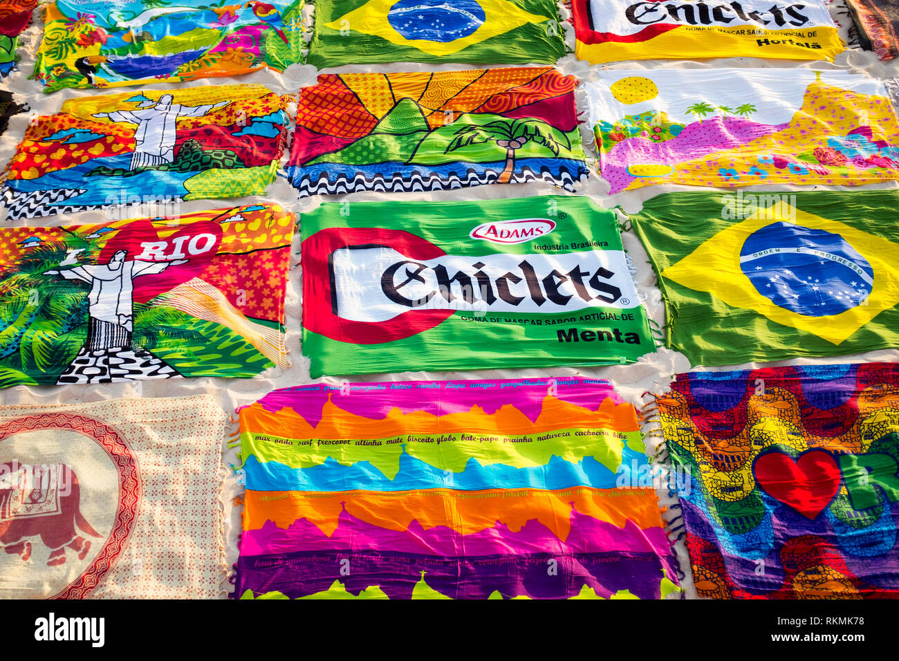 RIO DE JANEIRO - MARCH 15, 2015: Beach blanket sarongs known locally as canga spread out in colorful display along the Ipanema Beach boardwalk. Stock Photo