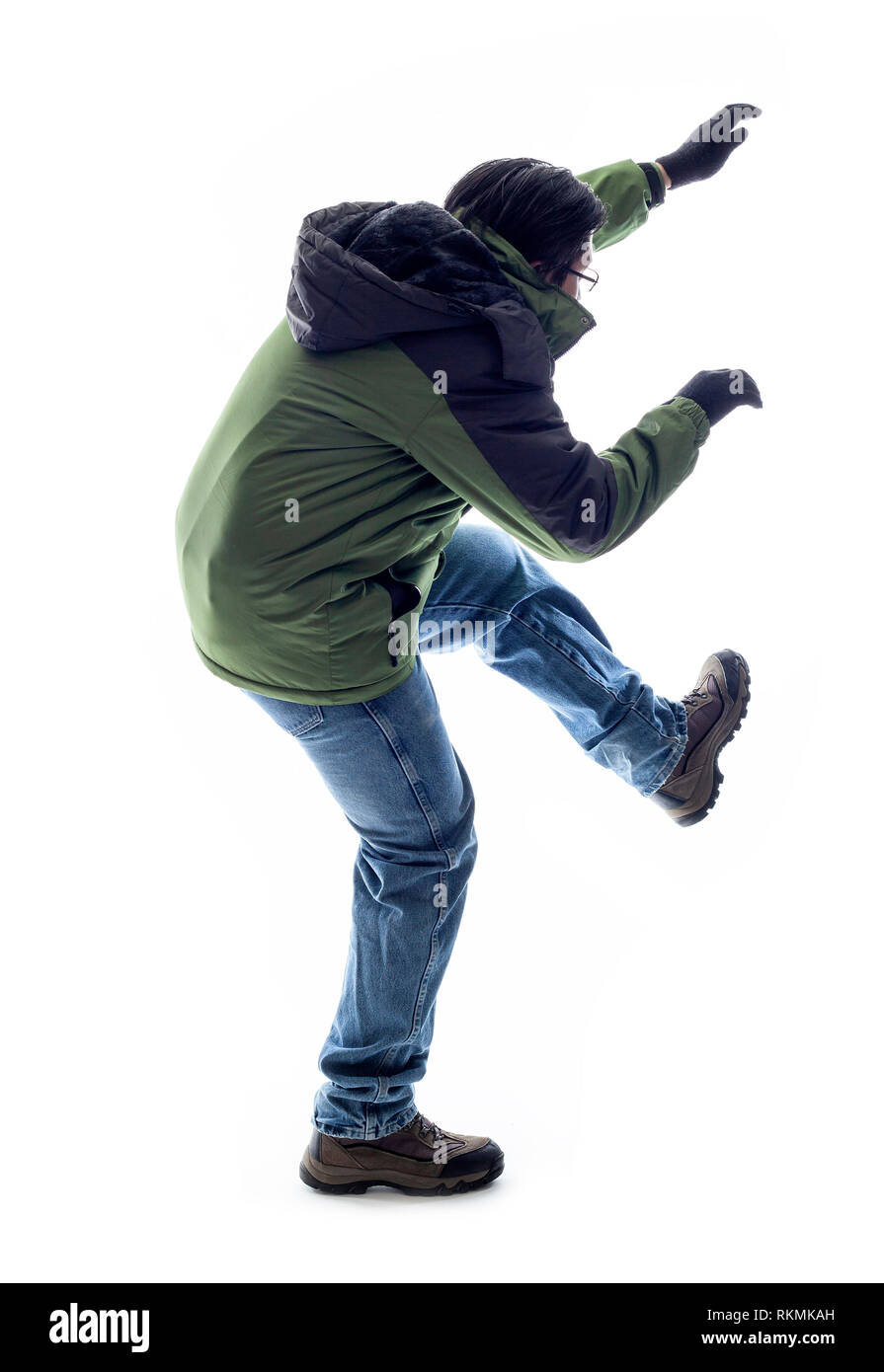Mountain climber or hiker isolated on a white background for composites.  The man is acting like he is climbing something and depicts adventure and ex Stock Photo