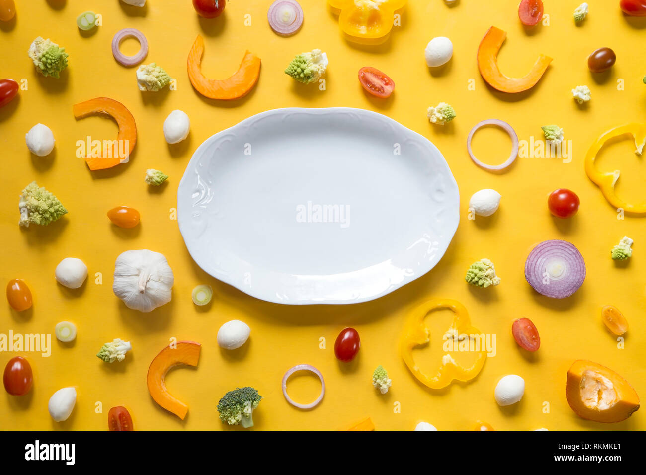Fresh sliced vegetables on yellow background Stock Photo