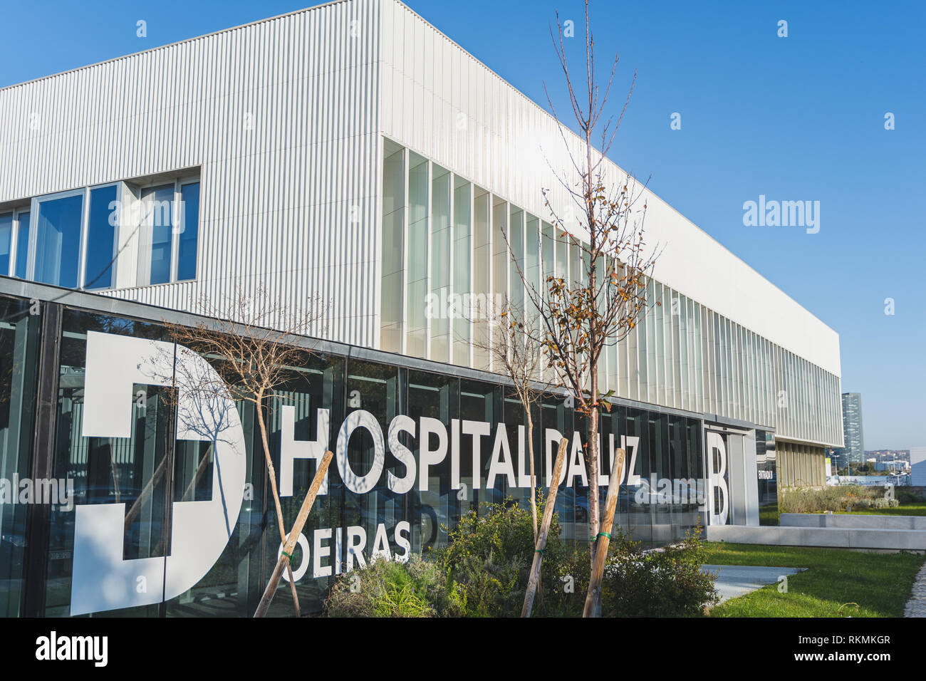 Oeiras, Portugal - 01/05/19: Hospital da Luz (of Light), Oeiras. Big sign with the logo of the private hospital. Emergency and general entrance. Blue  Stock Photo