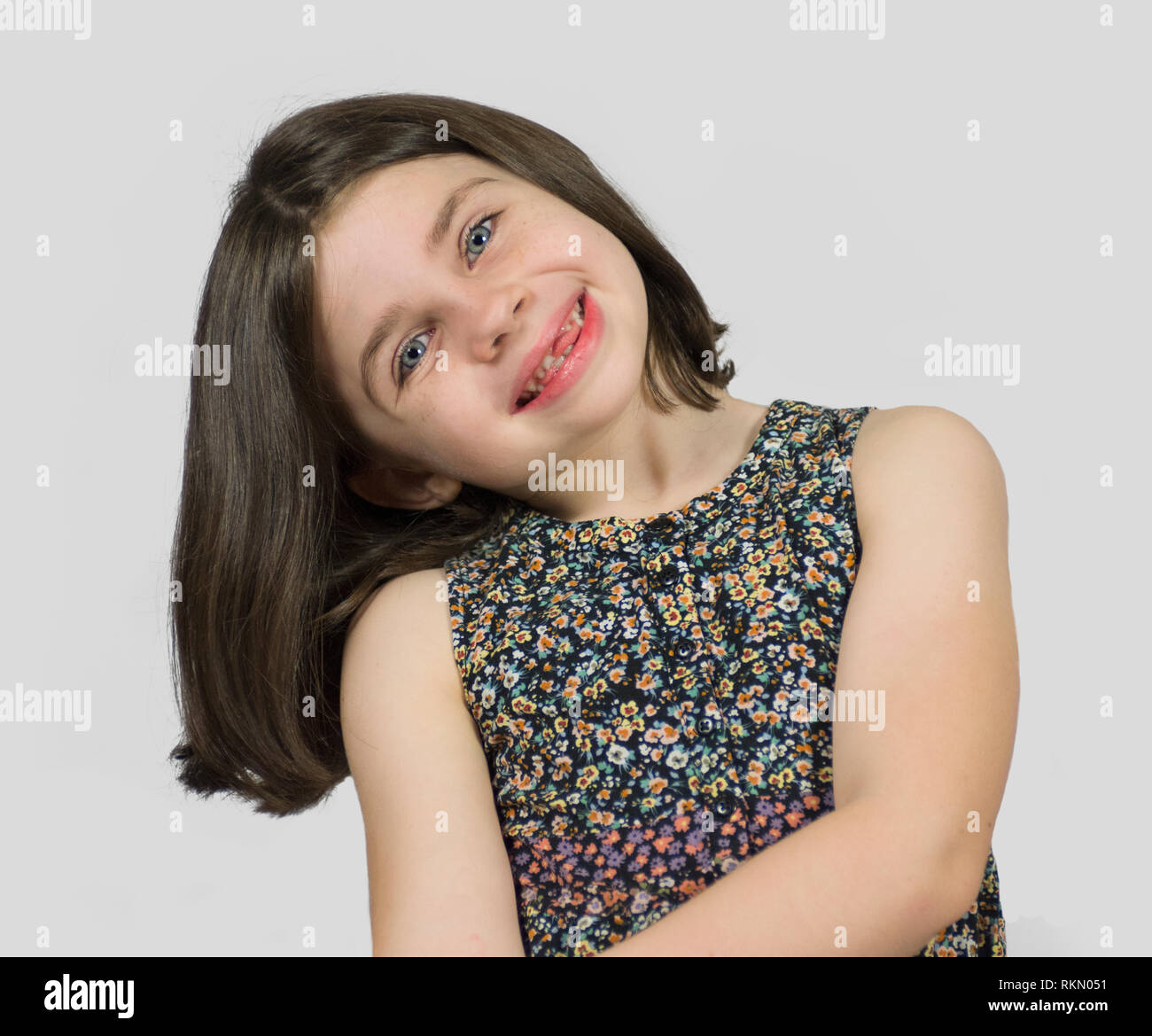 Headshot Of Smiling Little Girl With Short Bob Hair Cut Stock