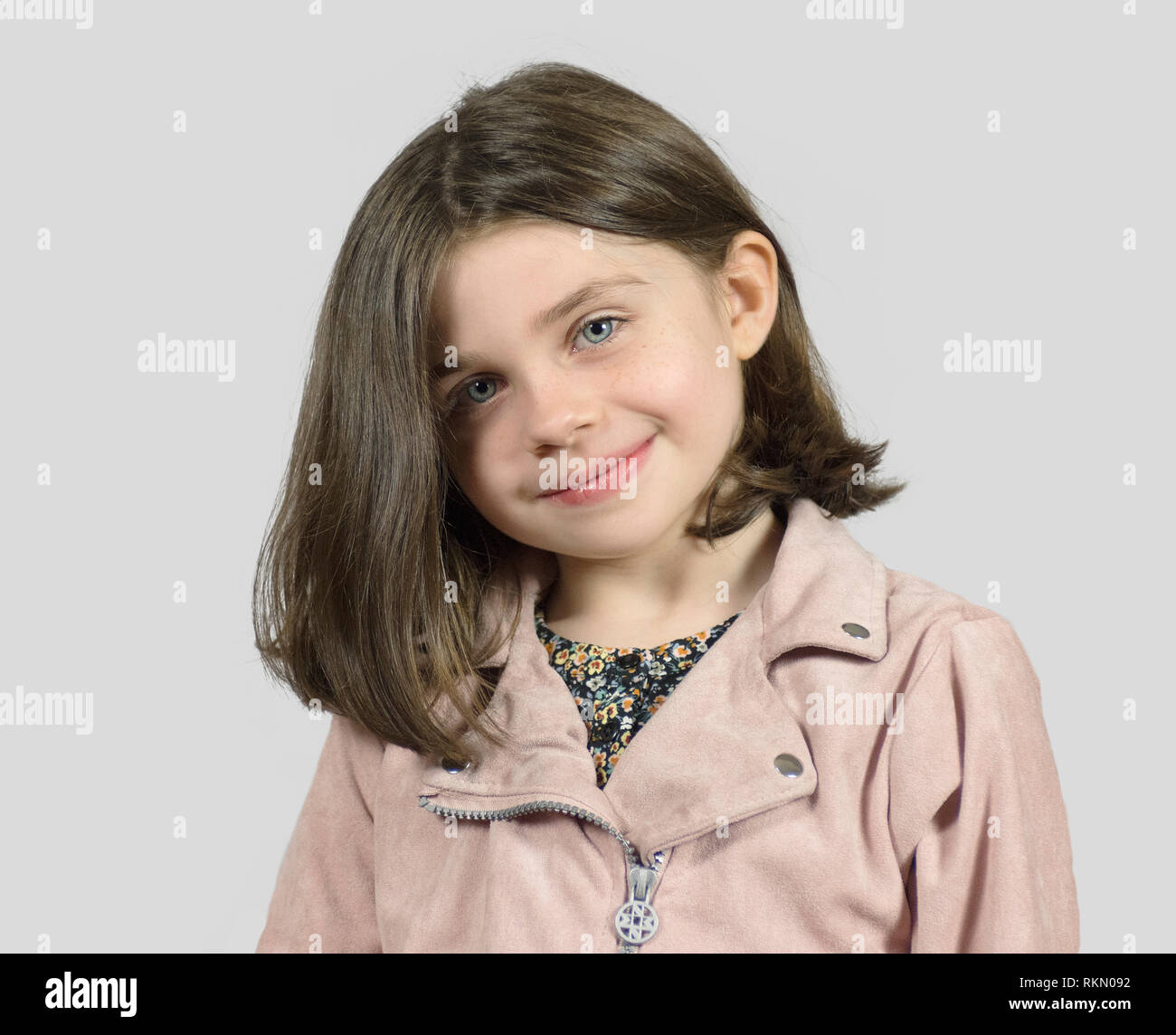 Headshot Of Smiling Little Girl With Short Bob Hair Cut Stock