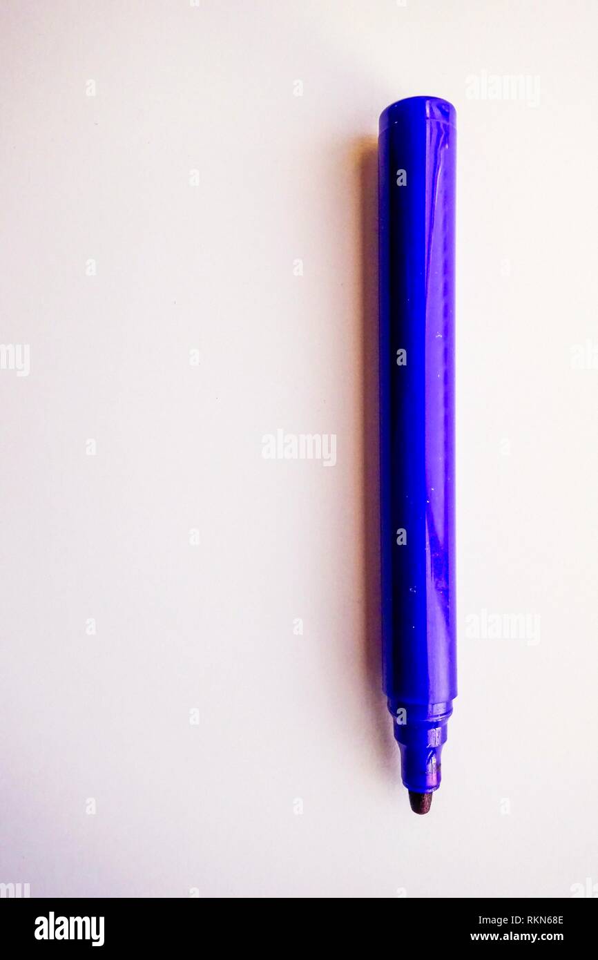 Blue Fibre Tip Marker Pen on single sheet of white paper Stock Photo