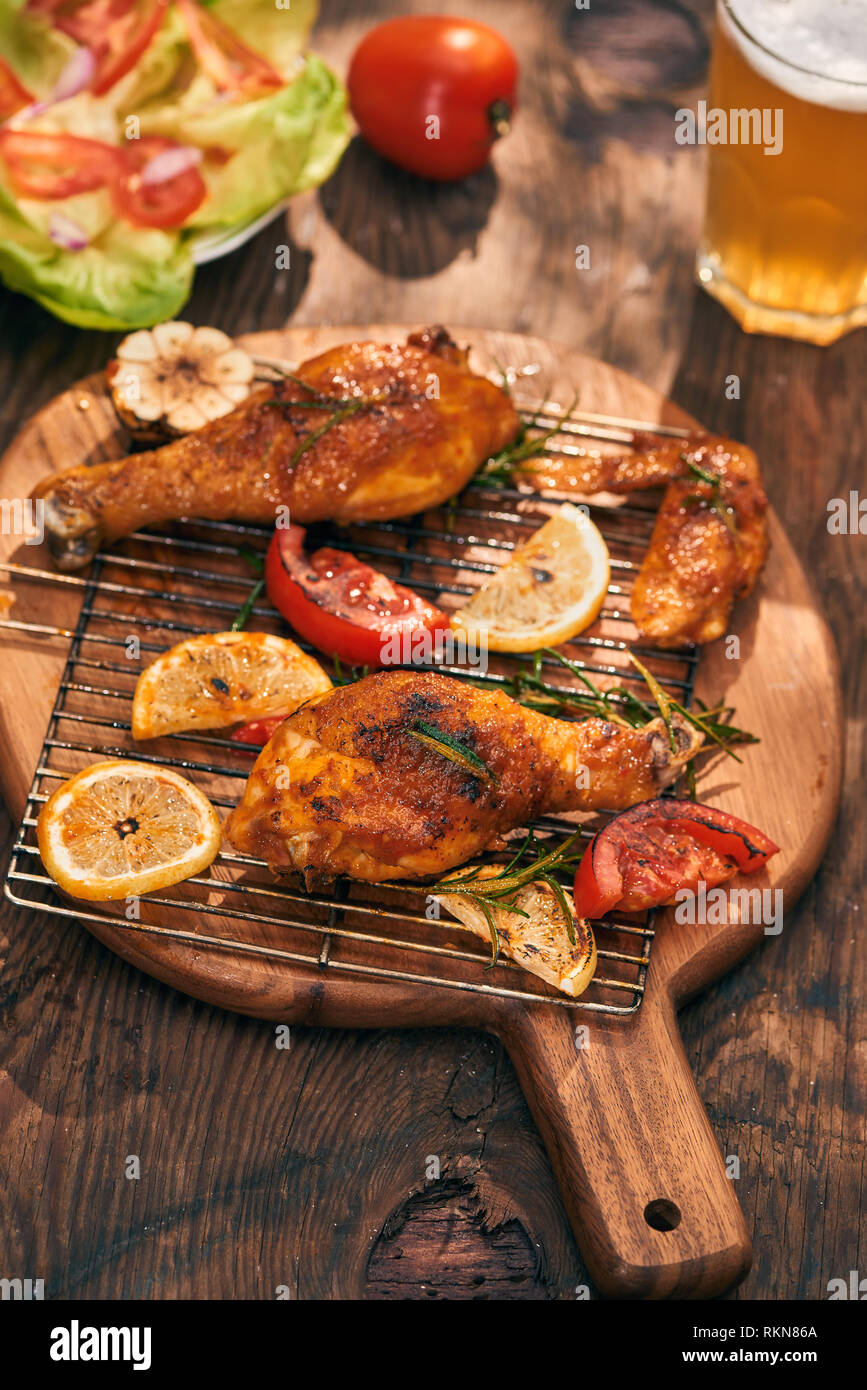 Hot and spicy chicken drumstick and wings closeup with beer Stock Photo