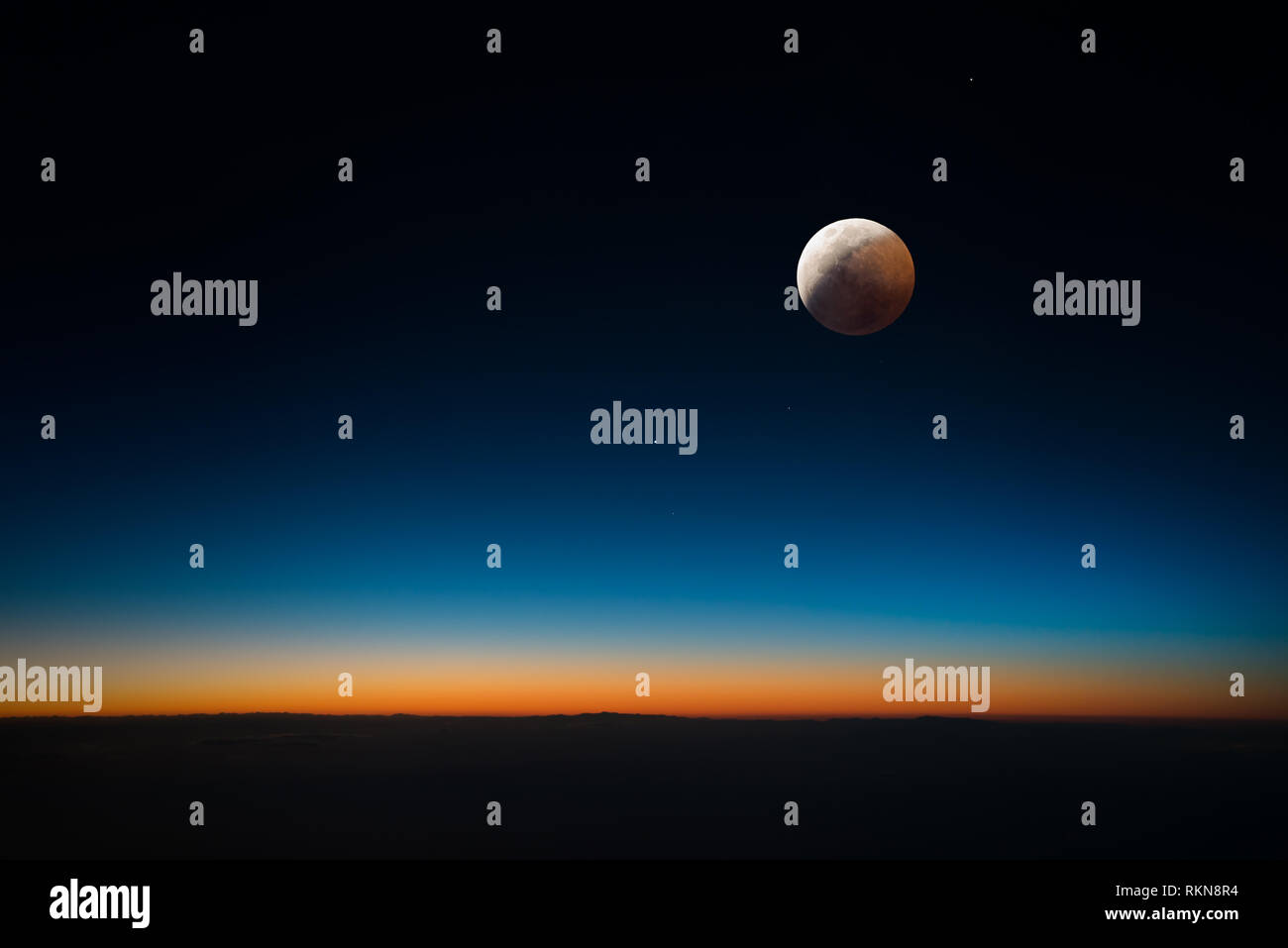 Eclipsed moon with sunlight bent by Earth's atmosphere making the moon appear red Stock Photo