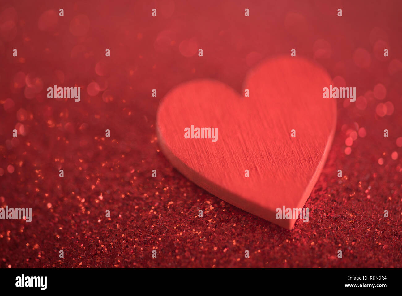 Red heart on glitter background in love concept Stock Photo