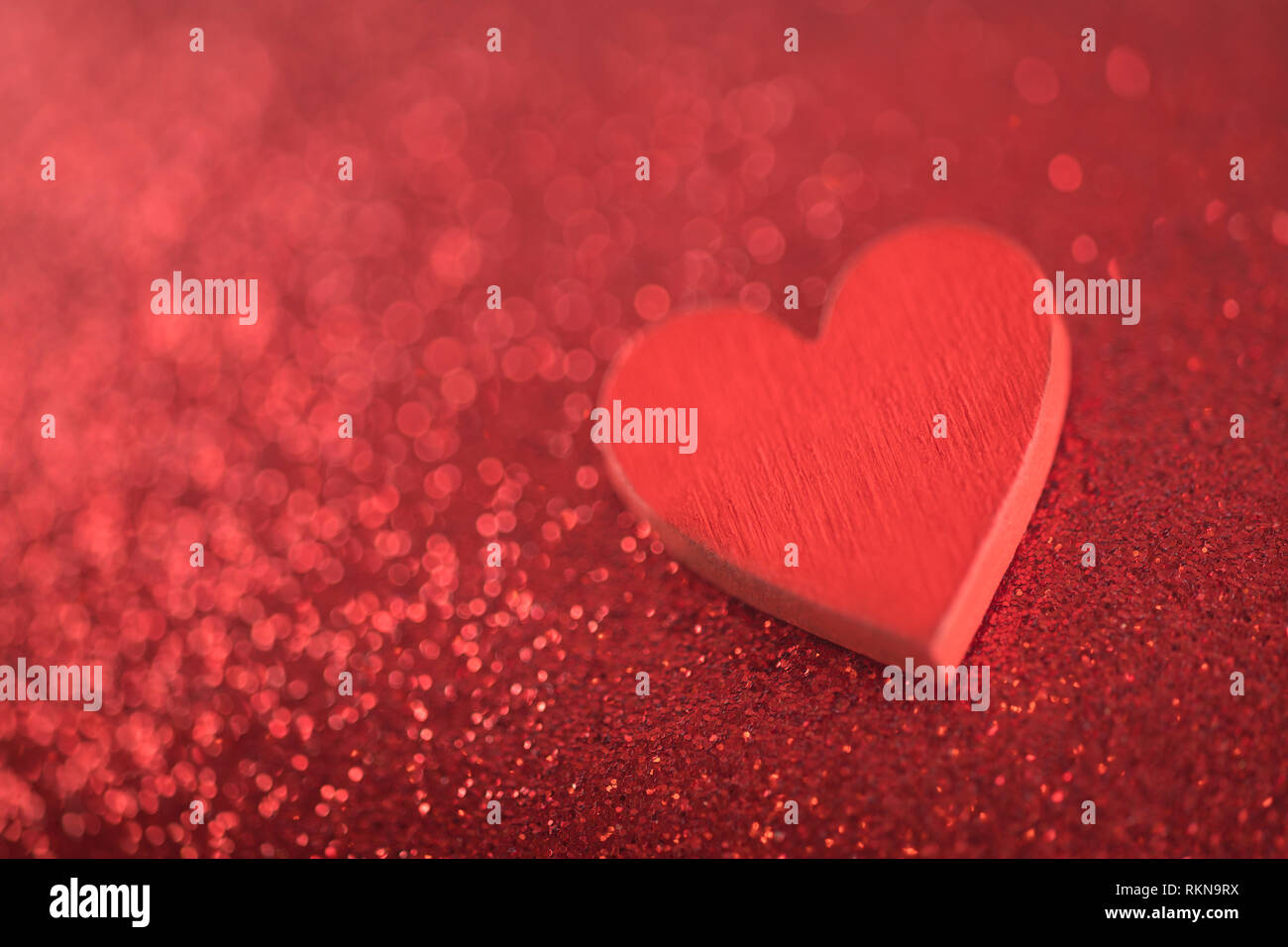 Red heart on glitter background in love concept Stock Photo