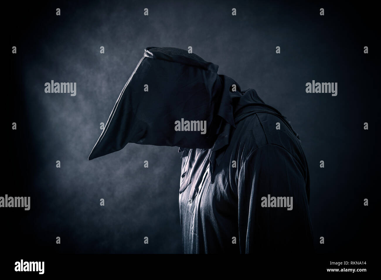 Spooky monster in hooded cloak Stock Photo