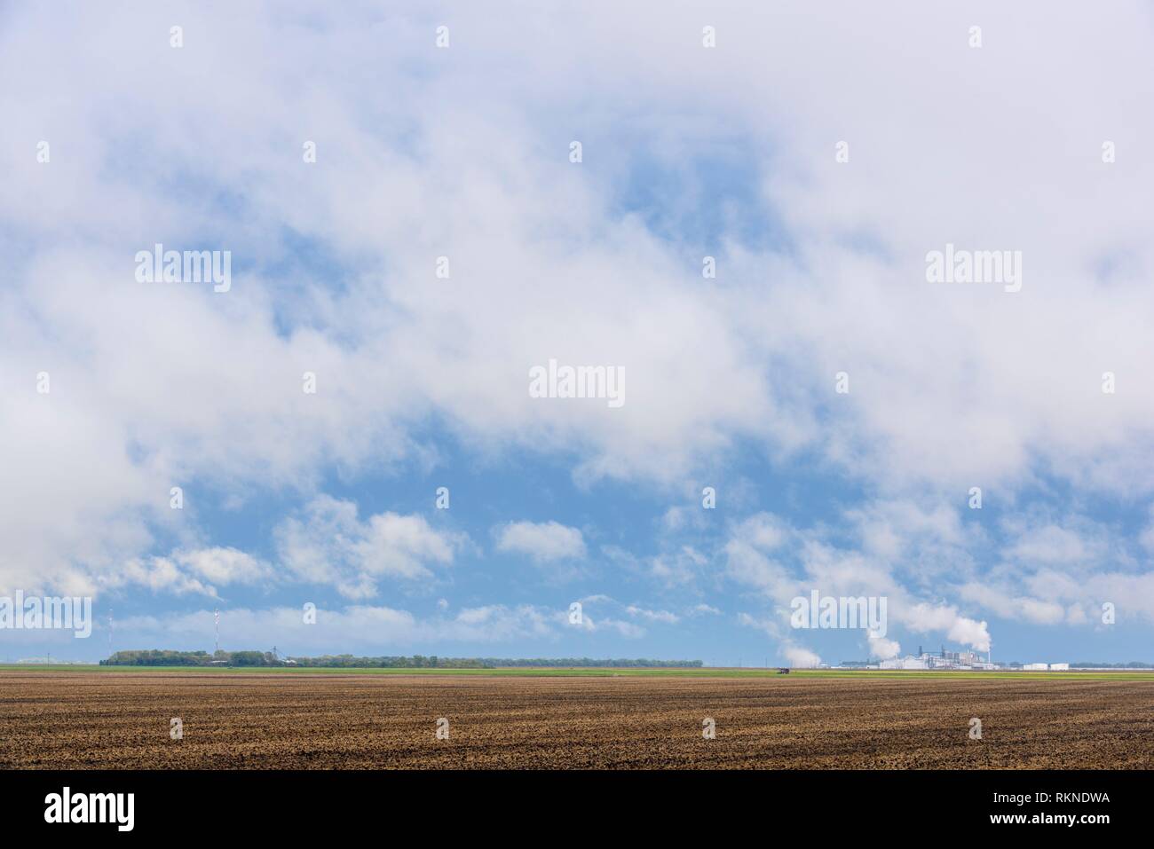 Clearing storm, agricultural fields and distant industrial complex, Fargo, North Dakota, USA. Stock Photo