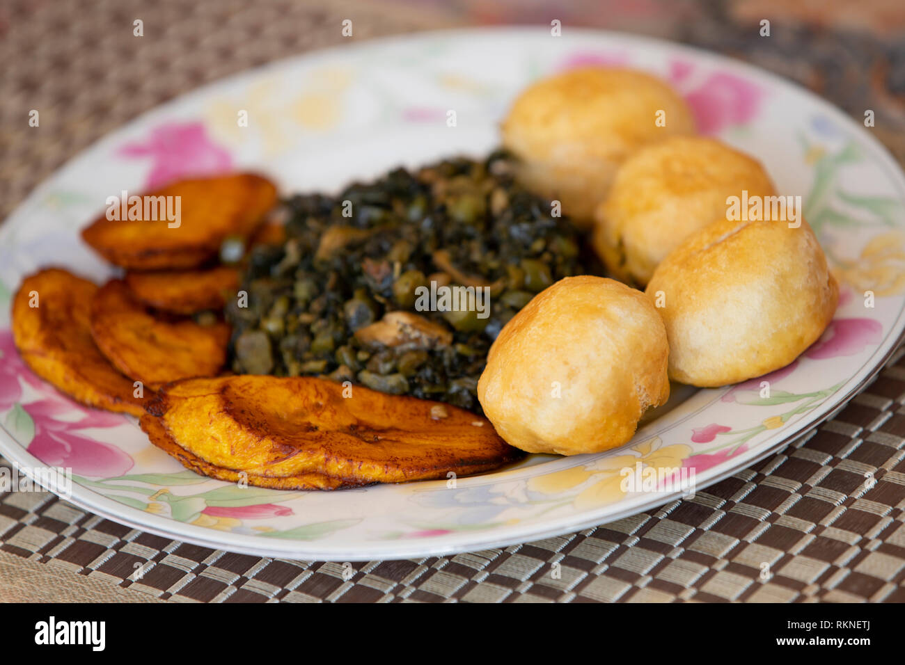 Jamaican Breakfast. Fried Plantains & Dumplings and callaloo Stock Photo