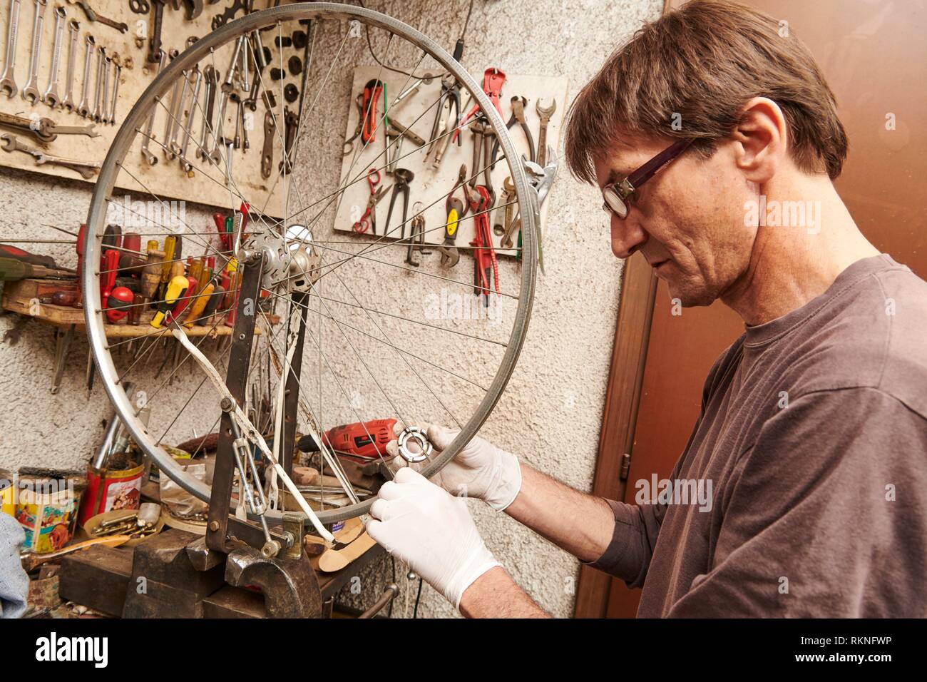 A technician restoring a vintage bicycle Stock Photo Alamy
