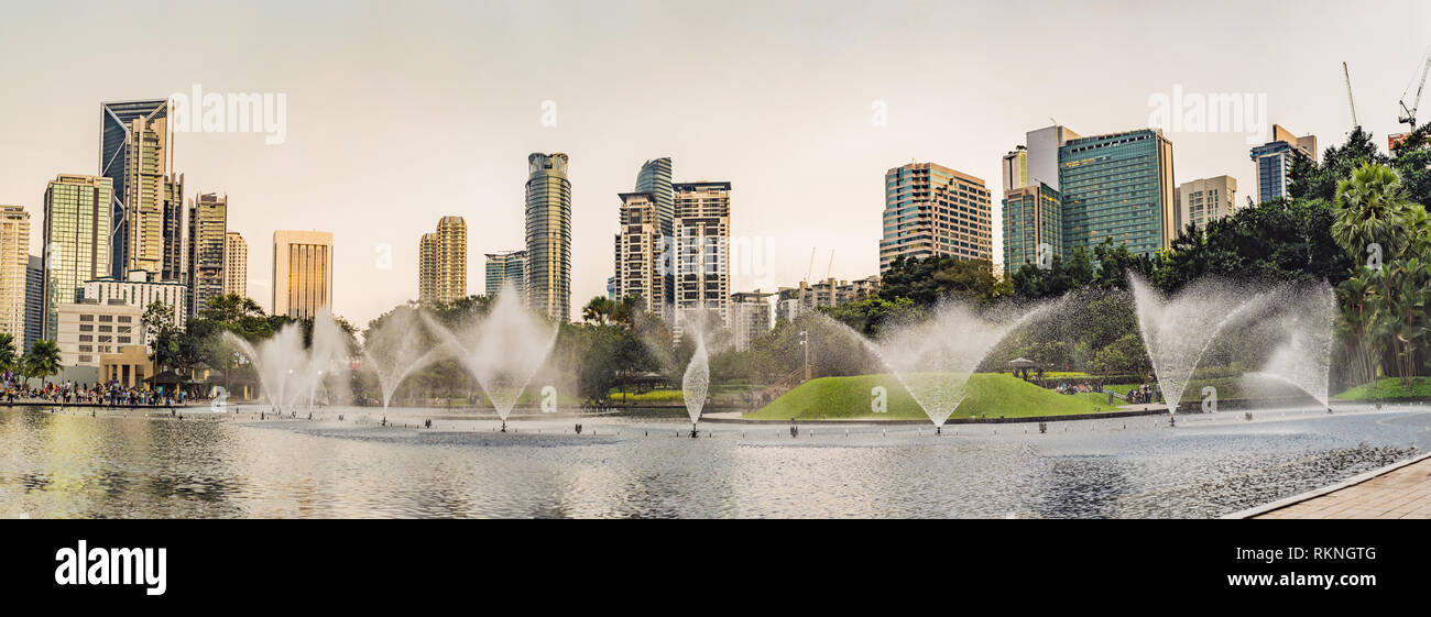 Fountain on the lake in the evening near by twin towers with city on