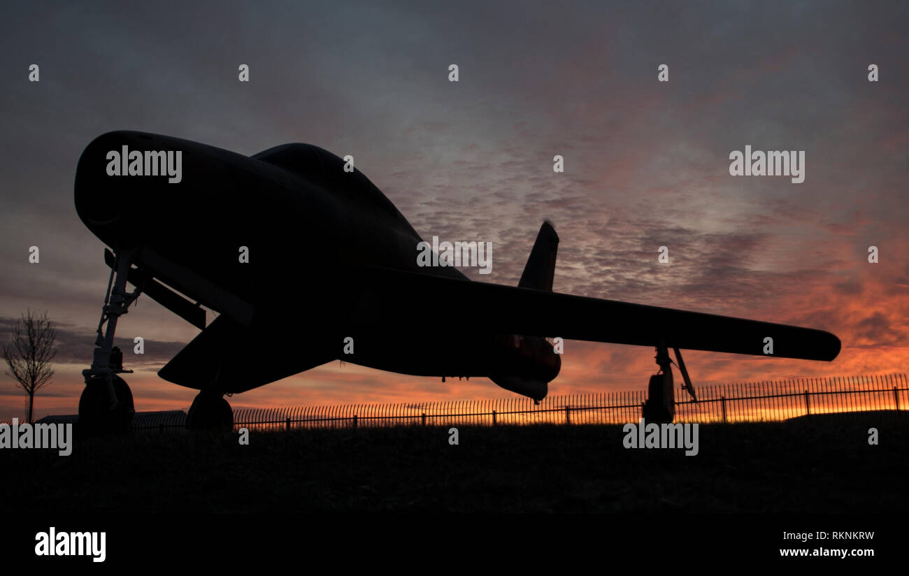 The sun rises over a Republic F-84F Thunderstreak static display Feb. 10, 2019, at the 179th Airlift Wing, Mansfield, Ohio. The Thunderstreak was an American-built swept-wing turbojet fighter-bomber. (U.S. Air National Guard photo by Senior Airman Megan Shepherd) Stock Photo