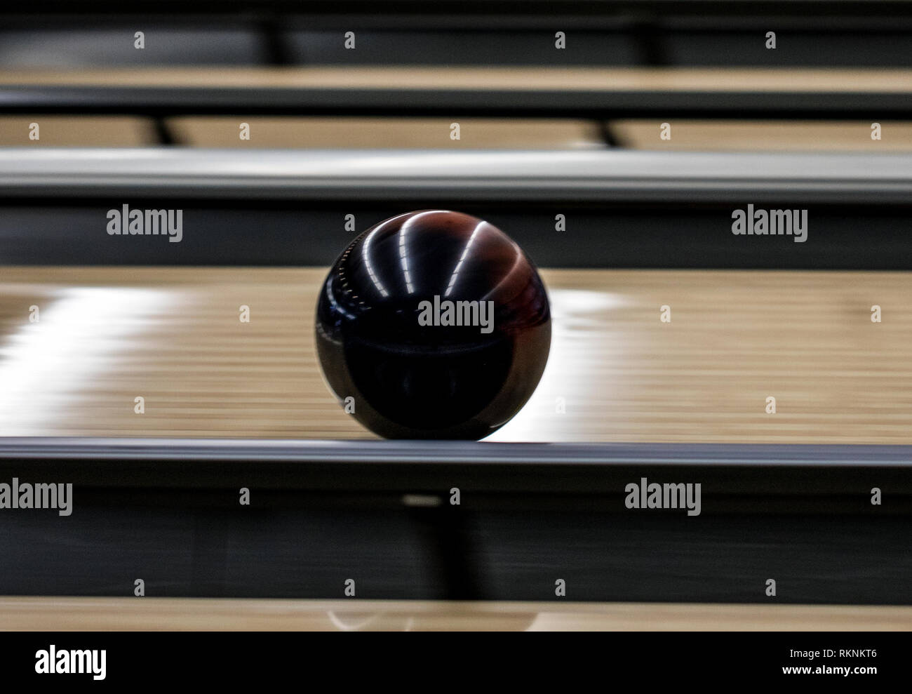 A bowling ball rolls down a lane at the Strike Zone bowling alley on Marine Corps Air Station Iwakuni, Japan, Feb. 7, 2019. Marine Corps Community Services, Single Marine Program, invited Japanese nationals from the Iwakuni Nursing Home to the air station for lunch and an afternoon of bowling. The event allowed both parties to share a cultural exchange through friendly competition and strengthen the everlasting bond between MCAS Iwakuni and the local community. (U.S. Marine Corps photo by Sgt. Joseph Abrego) Stock Photo