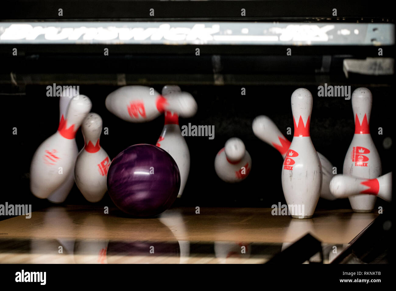 A bowling ball strikes pins at the Strike Zone bowling alley on Marine Corps Air Station Iwakuni, Japan, Feb. 7, 2019. Marine Corps Community Services, Single Marine Program, invited Japanese nationals from the Iwakuni Nursing Home to the air station for lunch and an afternoon of bowling. The event allowed both parties to share a cultural exchange through friendly competition and strengthen the everlasting bond between MCAS Iwakuni and the local community. (U.S. Marine Corps photo by Sgt. Joseph Abrego) Stock Photo