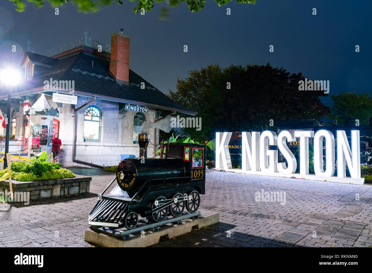 Night view of the Kingston sign with the visitor centre at Ontario