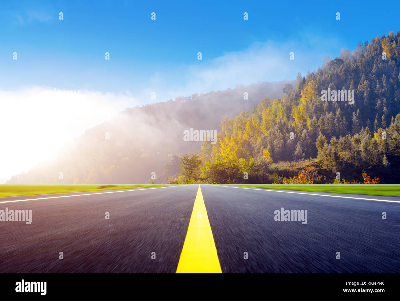 The highway leads to the distant mountains Stock Photo