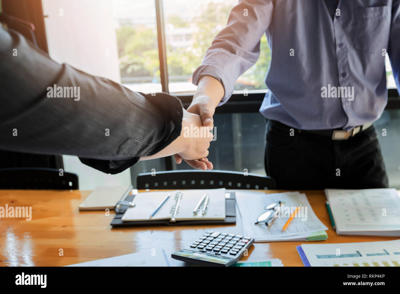 Business people shaking hands finishing up a meeting. Two confident businessman shaking hands during a meeting in the office, success, dealing, greeti Stock Photo