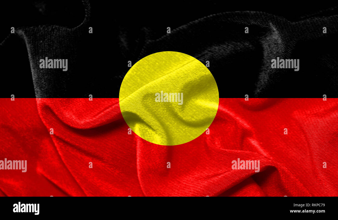 Realistic flag of Australian Aboriginal on the wavy surface of fabric ...