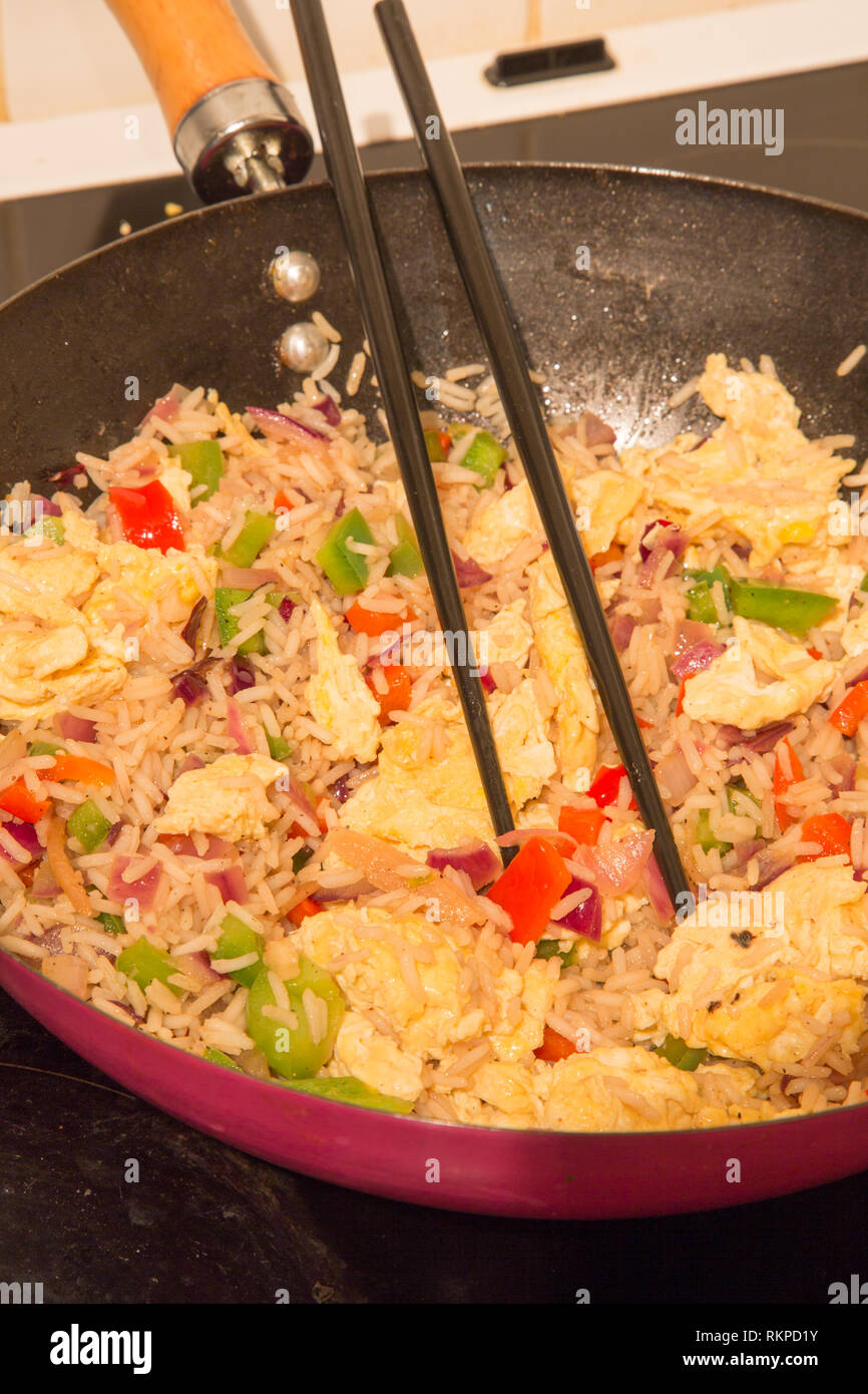 Chinese style Egg fried rice cooking in a wok Stock Photo