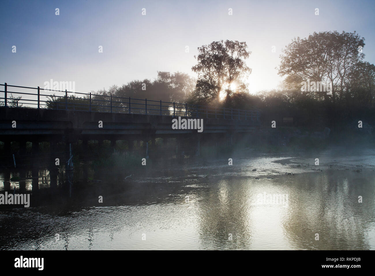 Bridge over the Mill Stream and early morning mist Ringwood Hampshire
