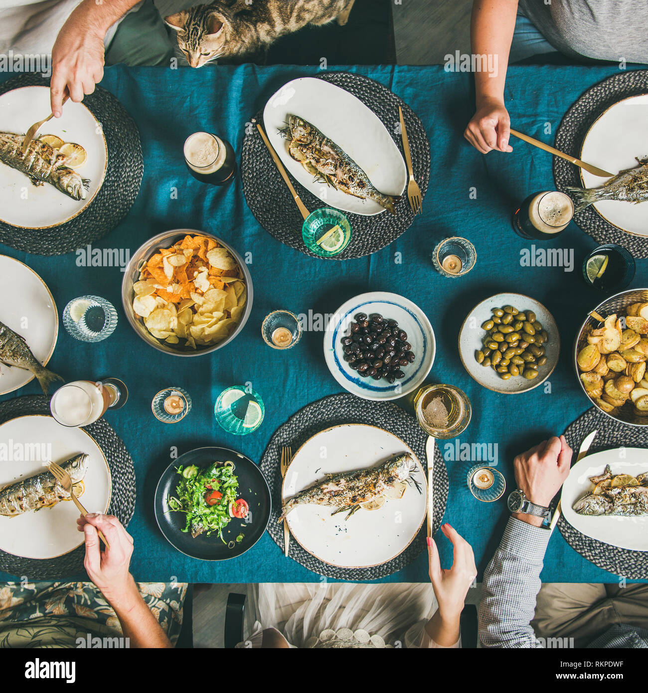 Flatlay of people eating fish and drinking beer, square crop Stock