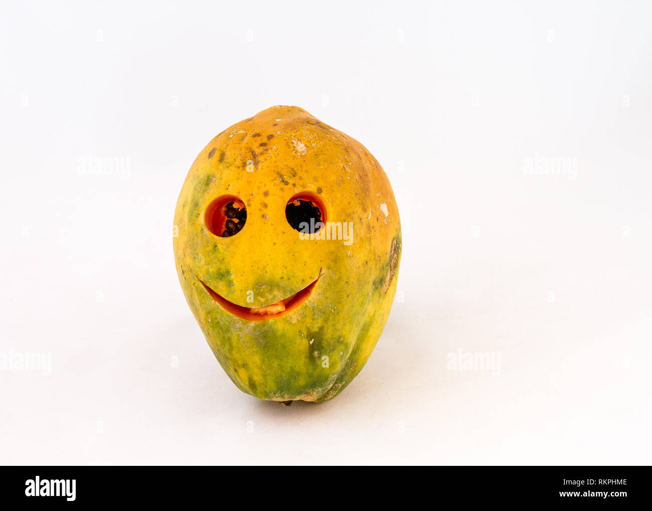 Pawpaw fruit with a smiling face isolated on a white background image