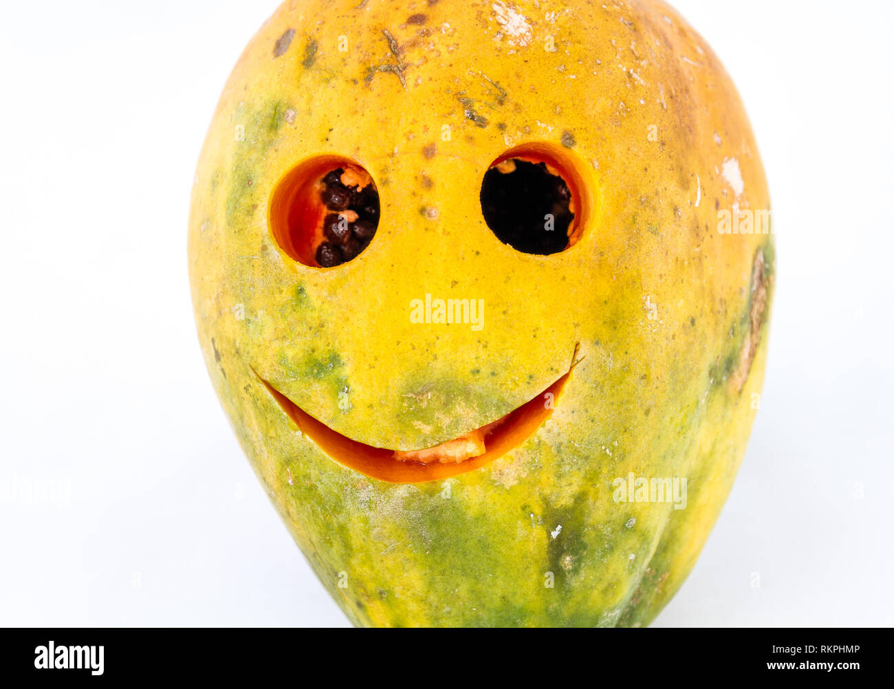 Pawpaw fruit with a smiling face isolated on a white background image