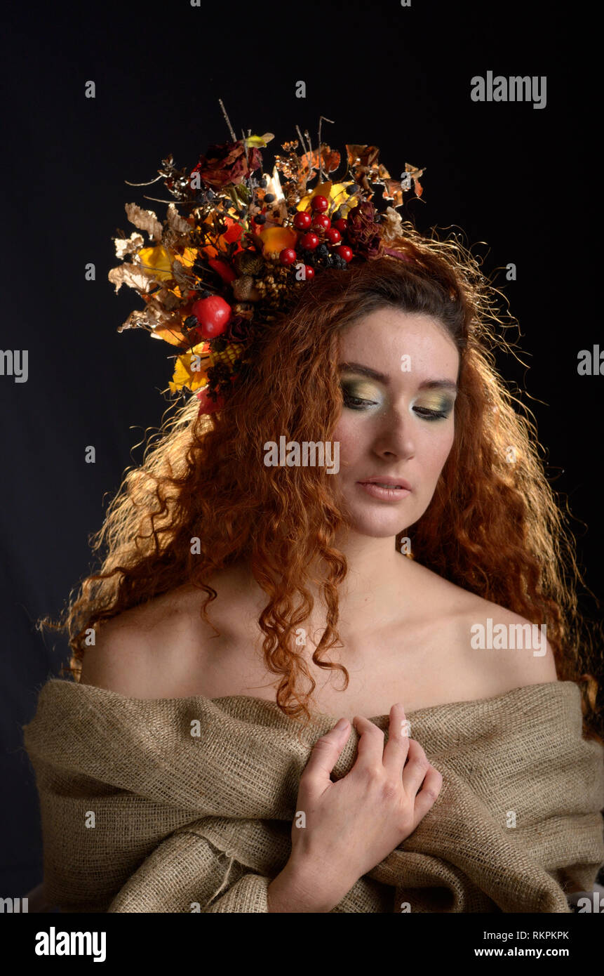 Portrait of young red haired caucasian woman with autumn headdres Stock Photo