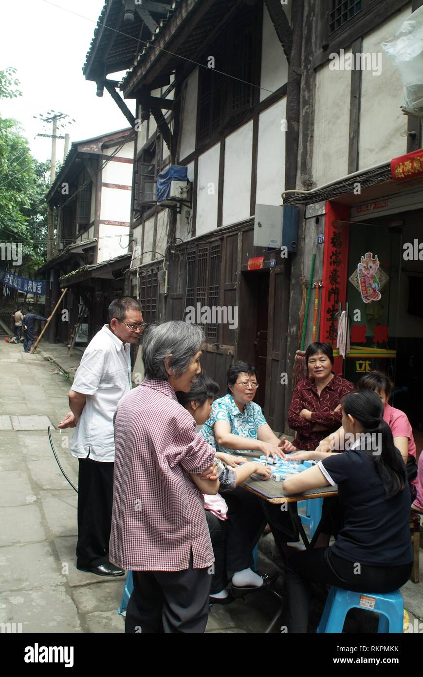 Playing majong in a back street of Ciqikou, a heritage town built