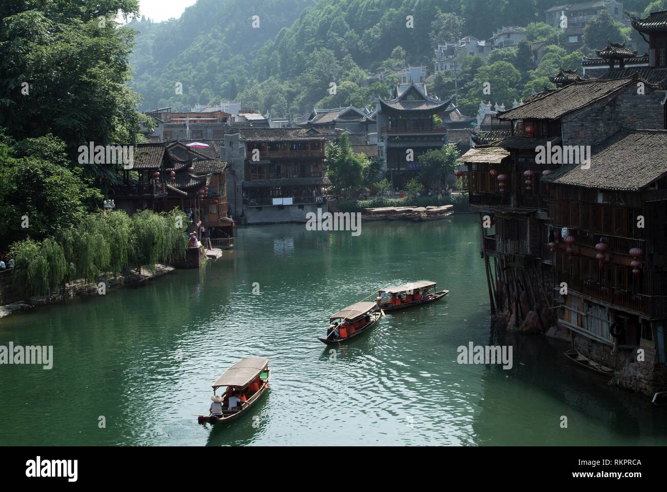 Tourists boats plying the Tou Jiang River in Fenghuang. Meaning
