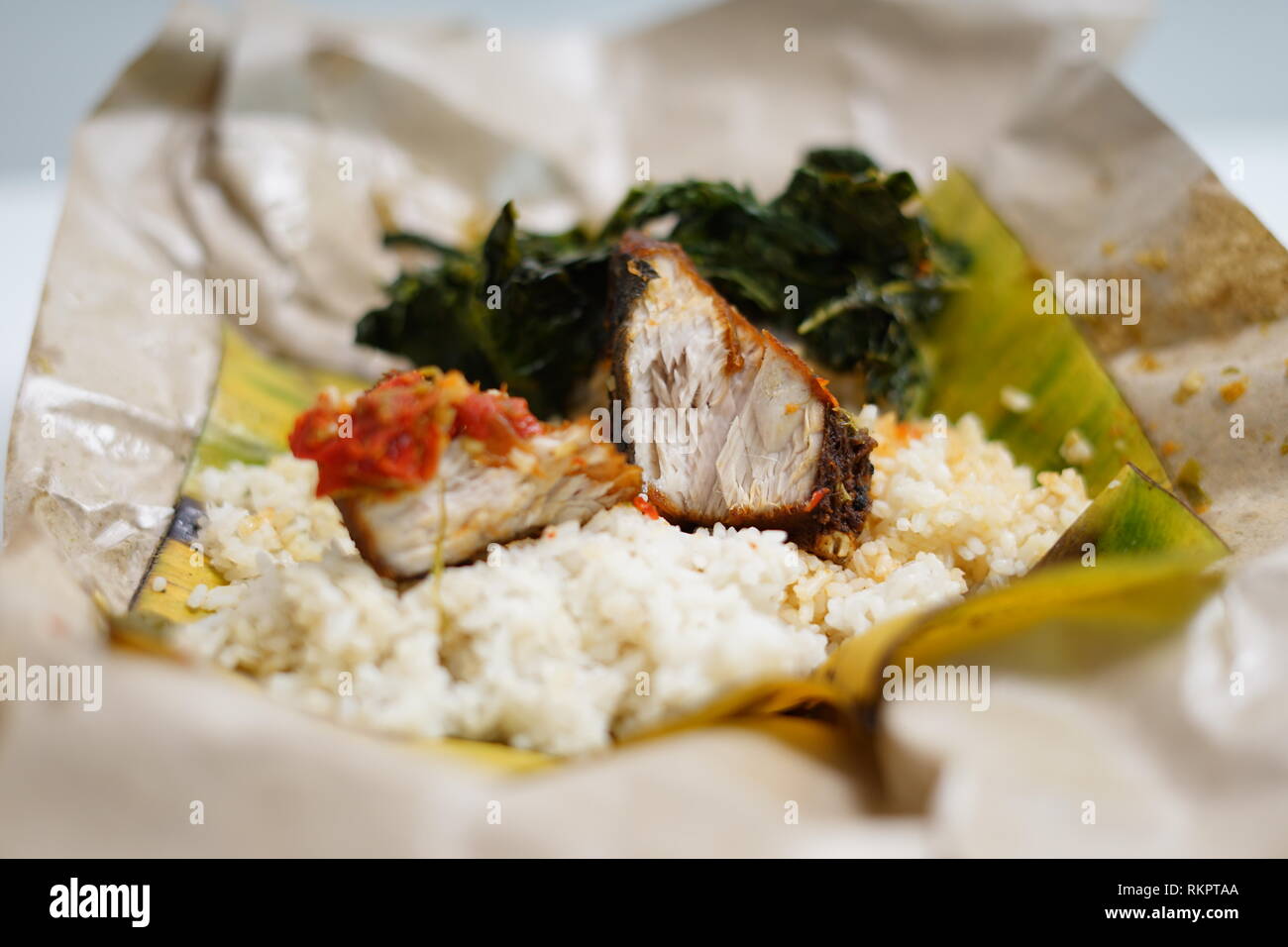 Fried Spicy tuna with Rice and vegetables (Nasi Bungkus Ikan Tuna Stock