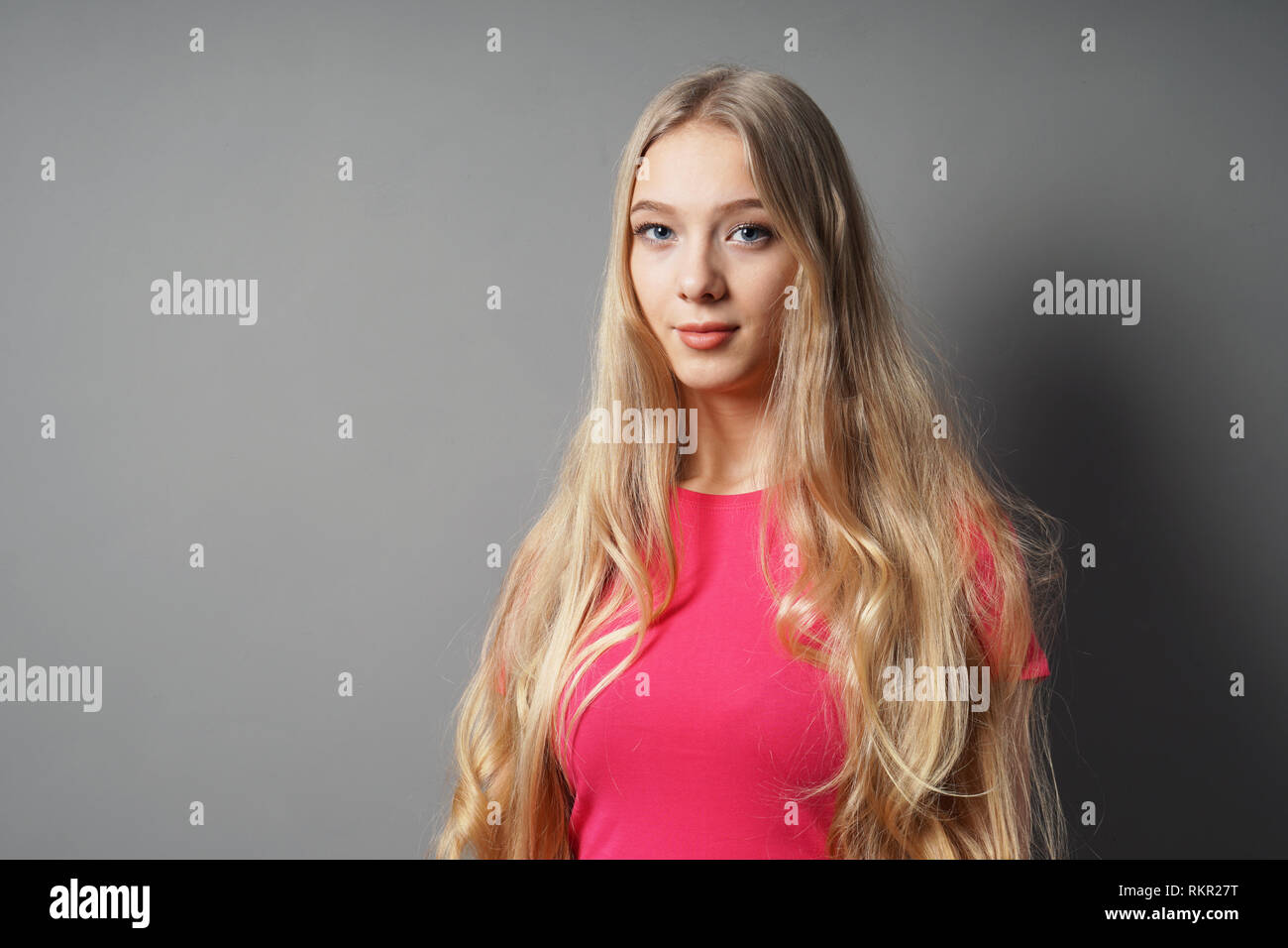 teenage woman with long blond hair and contented smile Stock Photo