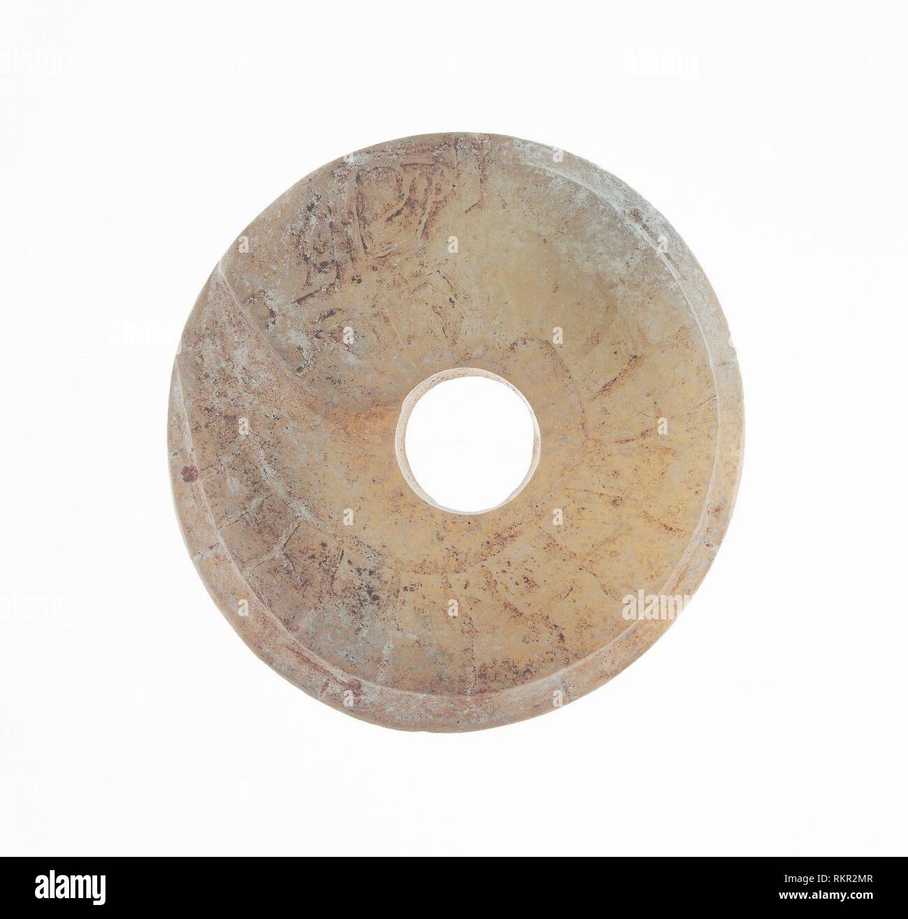 Disc with Coiled Dragon - Western Zhou period, 11th/10th century B.C. - China - Origin: China, Date: 1100 BC–900 BC, Medium: Jade, Dimensions: Diam. Stock Photo