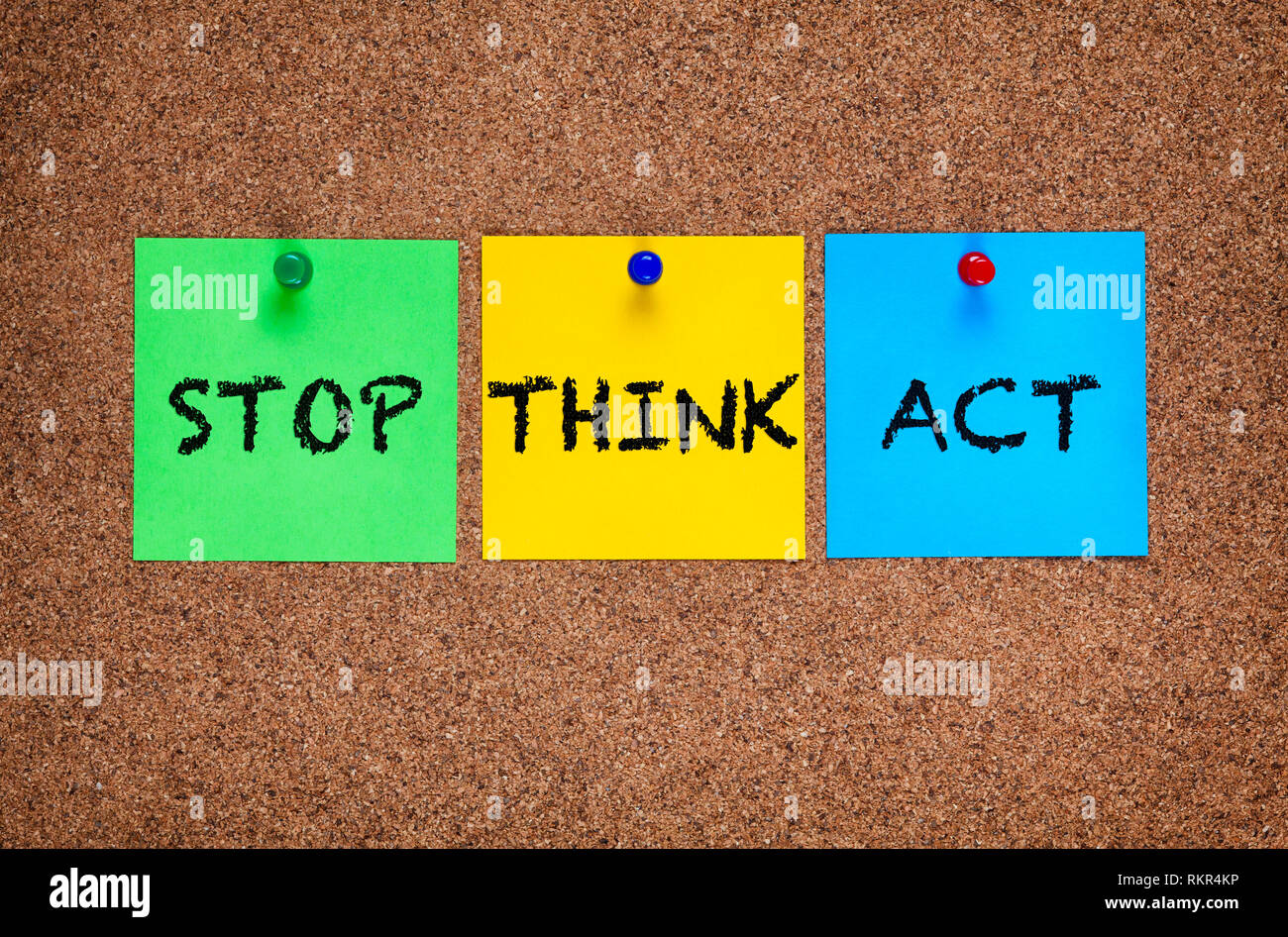 Three sticky notes on cork board with words Stop, Think, Act. Stock Photo