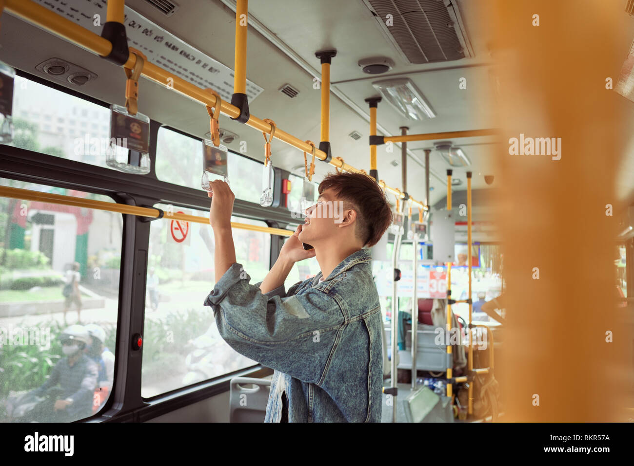 Handsome hipster modern man calling by mobile phone in bus Stock Photo