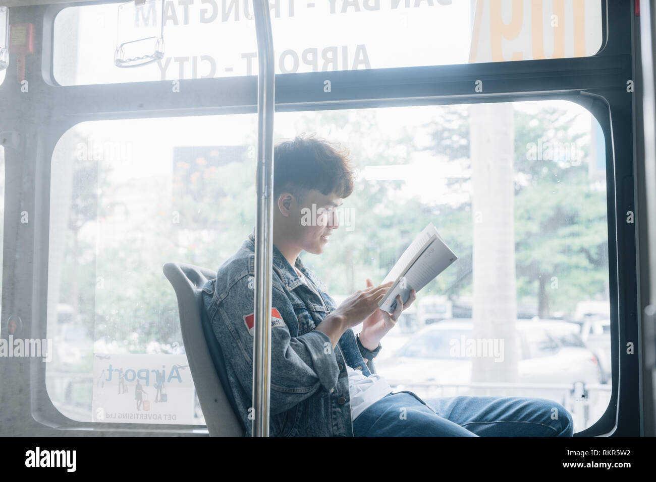 HO CHI MINH CITY, VIETNAM - 22 JULY, 2017: Transport: Transport. People in the bus. He reading book in transport. Stock Photo