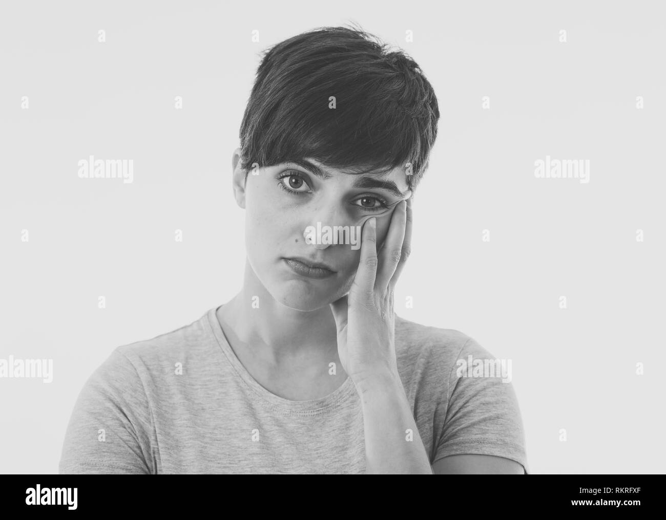 Close up portrait of beautiful young caucasian woman looking sad and stressed needing help. Isolated on white background in Human facial expressions,  Stock Photo