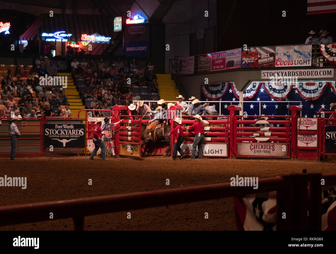 Texan cowboy riding horse at rodeo in Cowtown Coliseum, arena in the stockyards of Forth Worth, Texas, United States of America. Man and animal at sho Stock Photo
