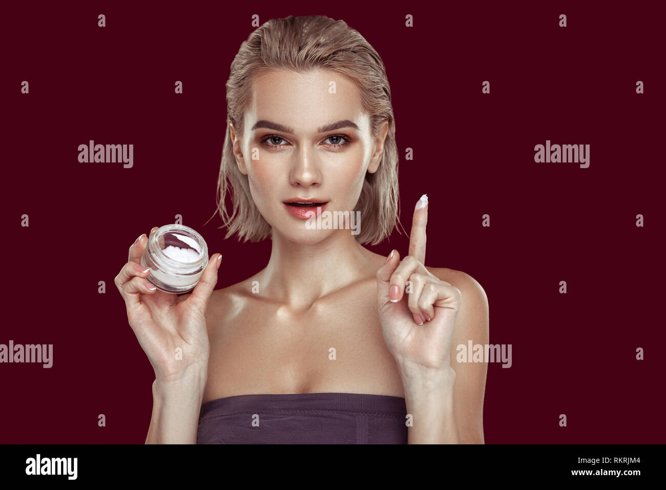 Dark-eyed photo model promoting cream posing for magazine Stock Photo