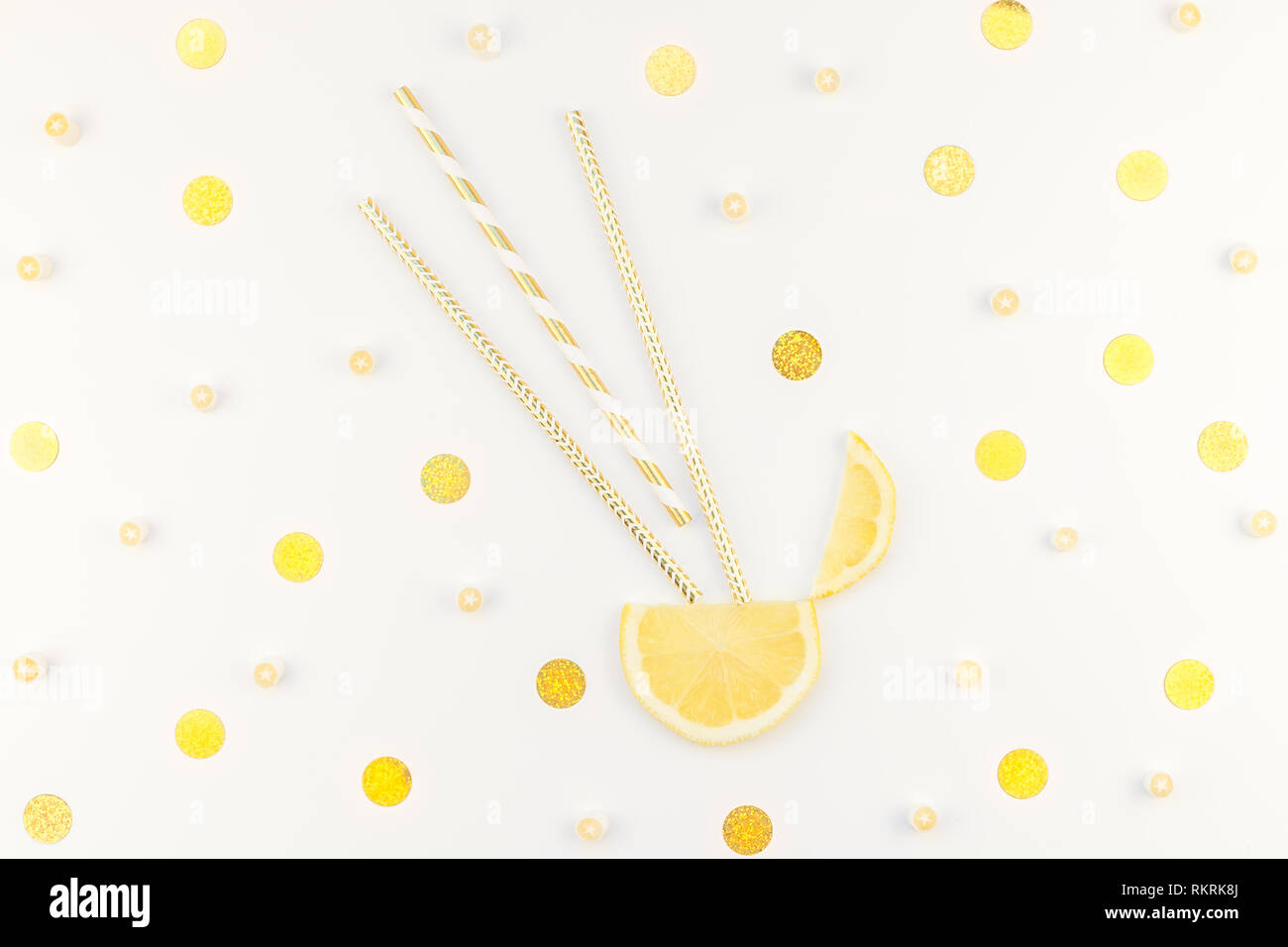 Creative flatlay overhead top view citrus lemon slices and candies white table background with copyspace. Hot summer refreshment lemonade concept. Bev Stock Photo