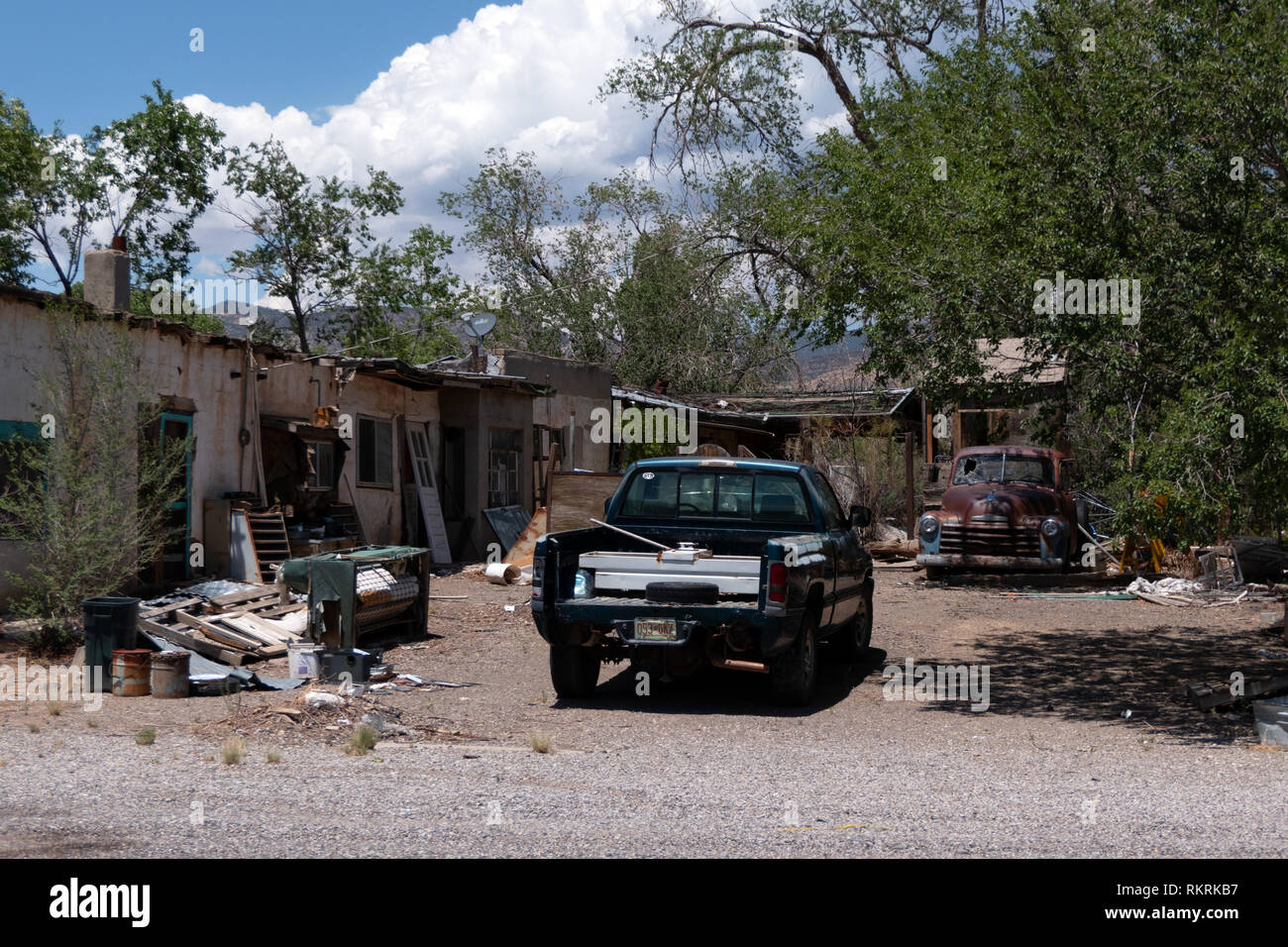 Backyard with old car and junk in San Fidel, New Mexico, United States of America Stock Photo