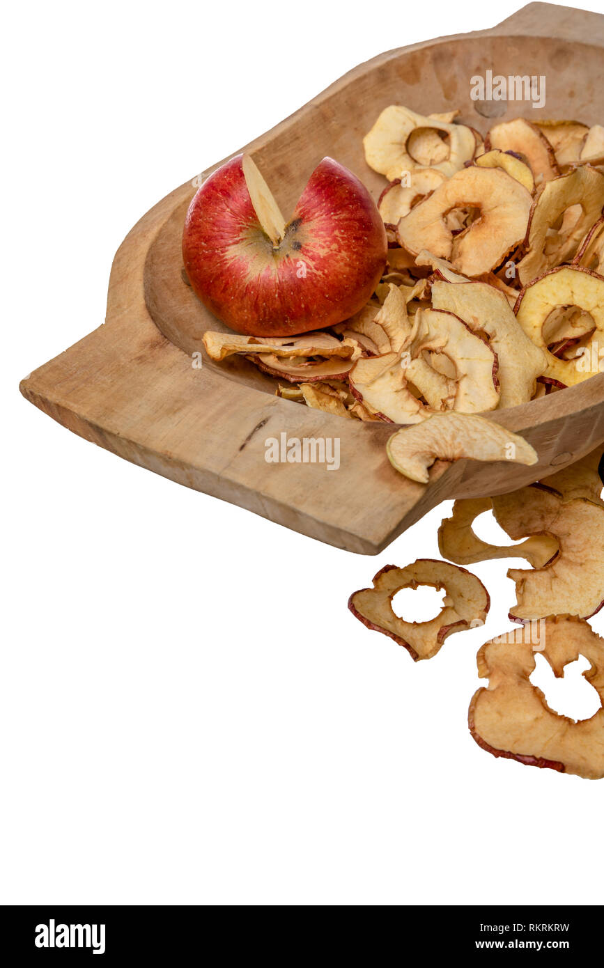 Dried apple rings lie on a board with a freshly cut apple Stock Photo