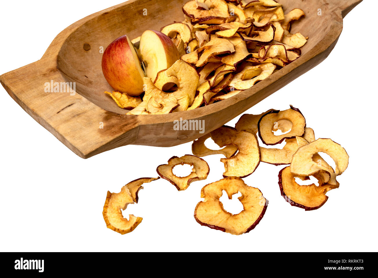 Dried apple rings lie on a board with a freshly cut apple Stock Photo