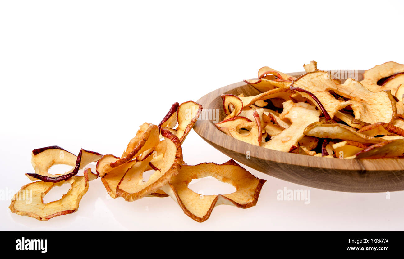 Dried apple rings lie on a board with a freshly cut apple Stock Photo