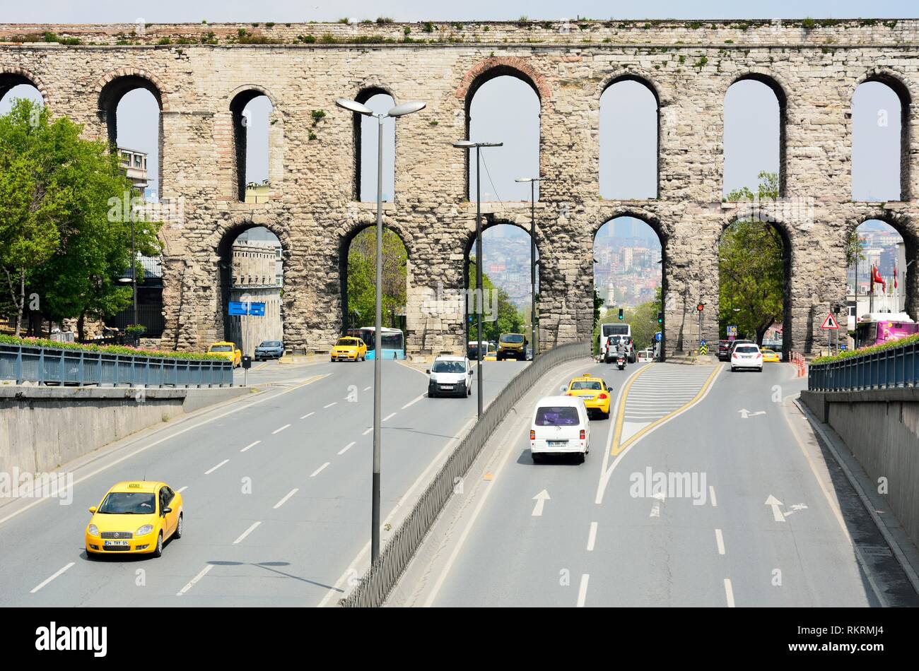 Istanbul, Turkey - April 23, 2017. Aqueducts of Valens rising over the traffic of busy Ataturk Caddesi in Istanbul. Stock Photo